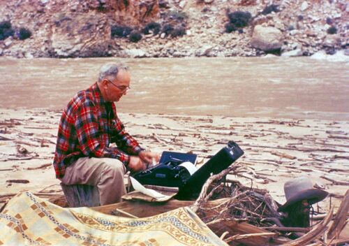 Randall Henderson typing his notes during his traverse of the Grand Canyon 1947.jpg